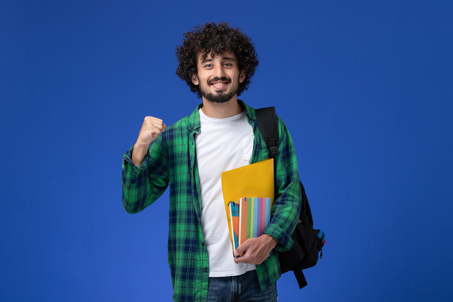 front view male student wearing black backpack holding copybooks and files on blue background university college lesson school